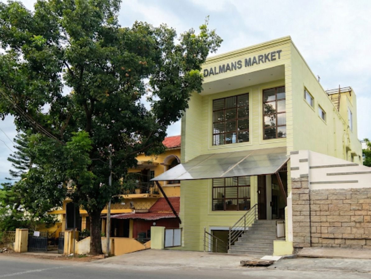 Commercial building on NRT Main Road, Theni with 21 ft road frontage and a grocery store at basement level